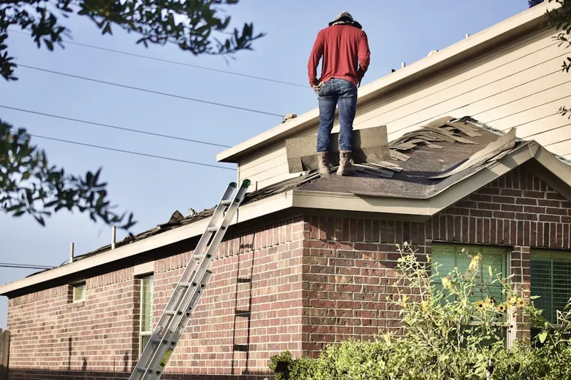 Professional roofer working on a residential roof in Flax Hill Elderly Housing
